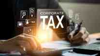 Professional calculating corporate taxes with digital tax icons and financial tools