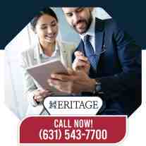 Two smiling business professionals in formal attire reviewing financial data on a digital tablet together.