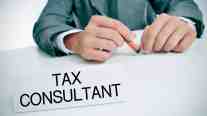 Business professional holding a pen above a sign labeled tax consultant