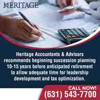 Business professional writing on financial documents with a calculator and paperwork.